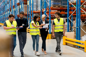 Workers with supervisors at warehouse
