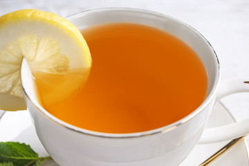 Cup of delicious tea with lemon, closeup