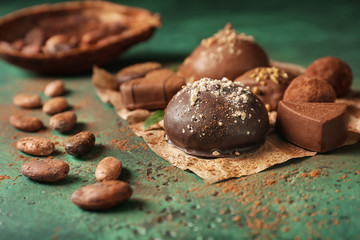 Different tasty chocolate candies on textured table