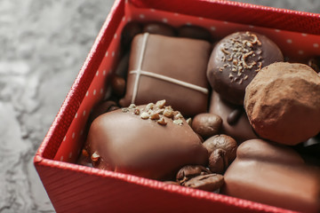 Box with different tasty chocolate candies, closeup