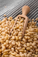 peeled pine nuts on a rustic background