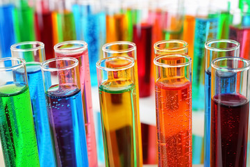 Many test tubes with colorful liquids, closeup