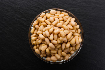 peeled pine nuts on a rustic background