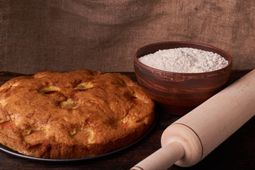 apricot pie and a bowl with flour and other ingredients and tools table