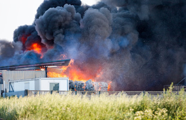 Fototapeta na wymiar Landfill fire with huge black cloud of smoke