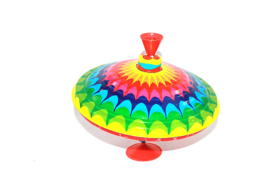 A Vintage 1970s Children's Spinning Top in Rainbow Colours on White 