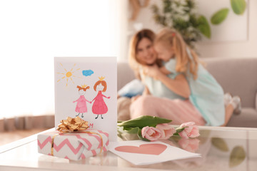 Lovely gifts from cute little girl for her mother on table