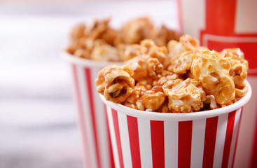 Paper bucket of tasty caramel popcorn, closeup