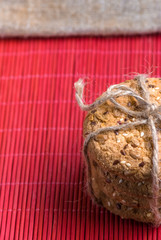 Savory cookies sprinkled with sesame seeds, sunflower on table and burlap background