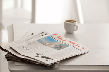 Heap of morning newspapers on white table - obrazy, fototapety, plakaty