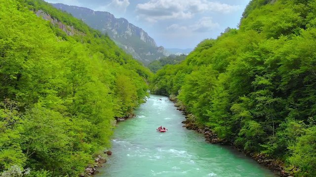 Aerial shot of people in boats whitewater rafting trip on Tara river in Montenegro, three boats