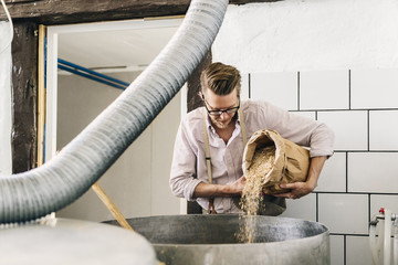 Worker making beer in local brewery