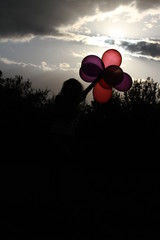 Silhouette of a woman with balloons