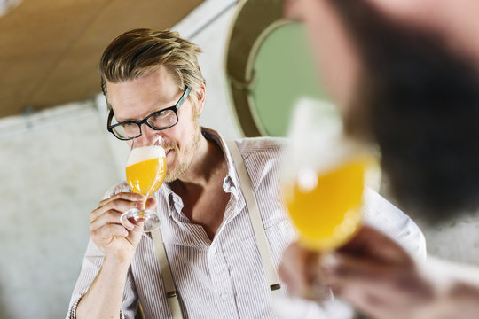 Two men drinking beer in local brewery
