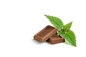 Broken milk chocolate and mint isolated on white background