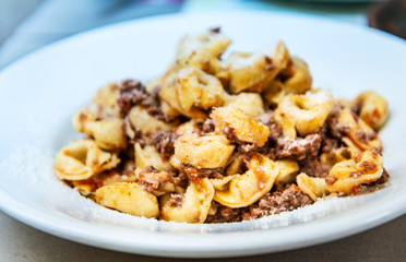 Pasta with pesto sauce and nuts on a the table