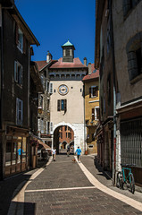 Street with old buildings and people in the city center of Annecy, a historic city in the department of Haute-Savoie, Auvergne-Rhone-Alpes region, southeastern France.