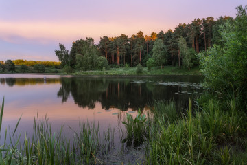 Fototapeta na wymiar Summer sunset after rain on the lake shore