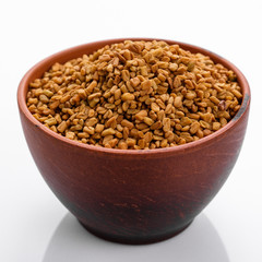fragrant grains of fenugreek on a white background