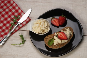 White cheese and cherry tomatoes on a slices of bread