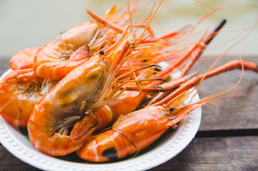 shrimp grilled on white plate on wooden table