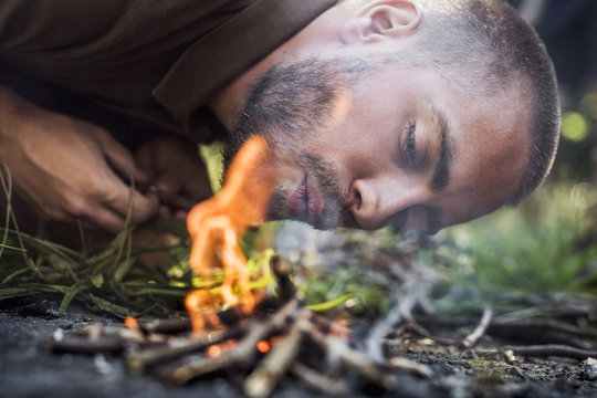 Man igniting camp fire