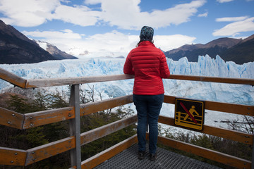 Fototapeta na wymiar Female Model with Red Jacket in front of Glacier