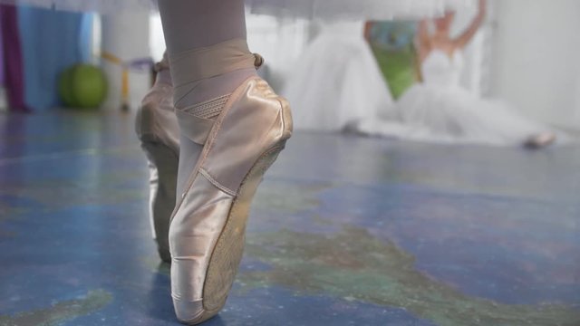 Ballet dancer's shoes on wooman's feet