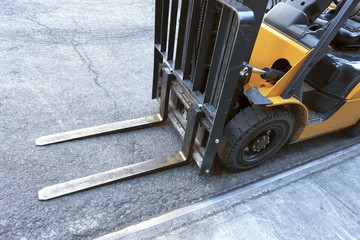 close up of fork lift blades on an urban city street