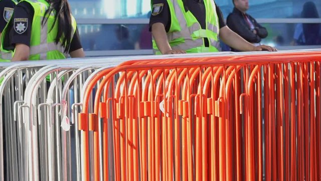 Security staff installing iron border to check tickets and control crowd of fans
