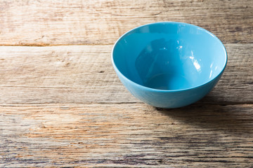 blue bowl on wooden background
