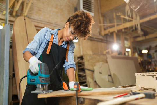 Afro american woman craftswoman working in her workshop

