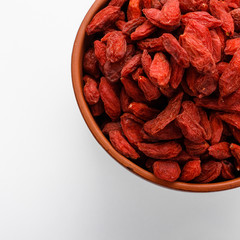 dried goji berries on a white acrylic background