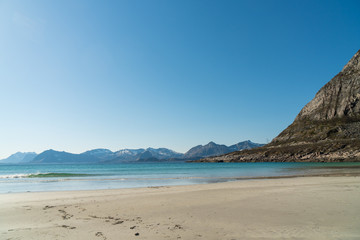 Waves at Rorvikstranda beach and Gimsoystraumen fjord near Henningsvaer at Lofoten Islands / Norway