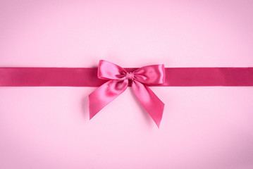 Pink bow on pink background.