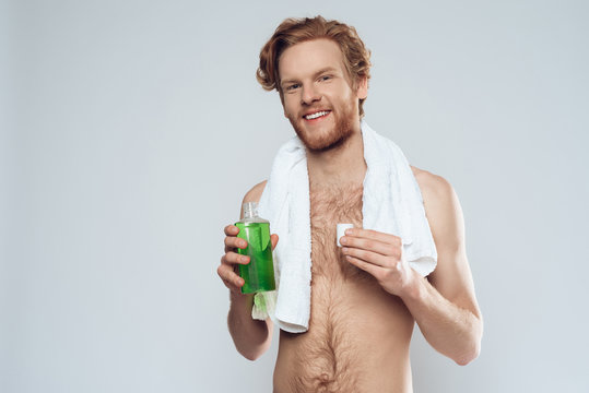 Red Haired Man Is Holding Mouthwash.