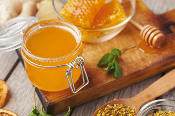 Jar of honey on wooden background