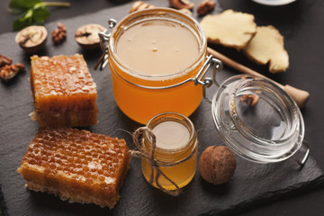 Various types of honey on wooden platter, closeup