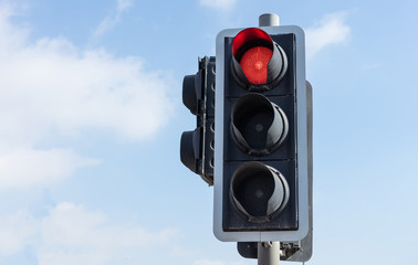 Red traffic lights for cars, blue sky background