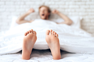 Red haired young guy is stretching, yawning