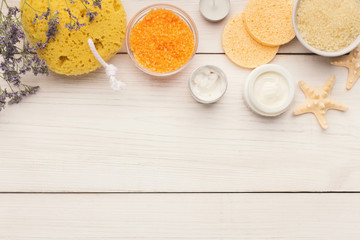 Spa background with facial mask and cream on white wood