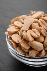 fresh peanuts on a dark stone background