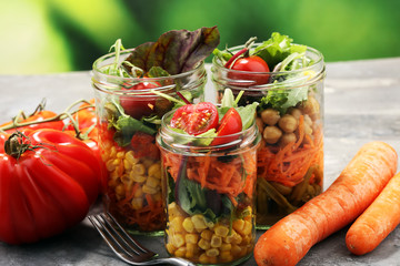 Homemade salad in glass jar with vegetables. Healthy food, diet, detox and clean eating