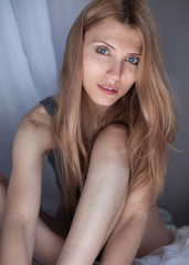 People and hope concept - close up of woman with long hear in gray lingerie