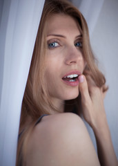 People and hope concept - close up of happy woman with long hear in gray lingerie