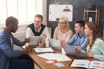 Young team discussing project in modern office