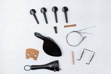 The violin parts.there are chin rest,peg,tailpiece,tailgut,saddle,bridge,tailpiece fret,sound post...