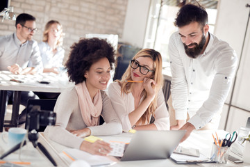 Image of three business people working at meeting.