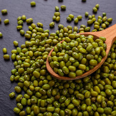 fresh Mung beans on a dark stone background
