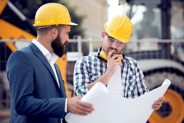 Happy engineer discussing with colleague